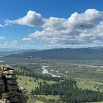 Orkhon River valley with eagles flying above forested landscape Mongolia